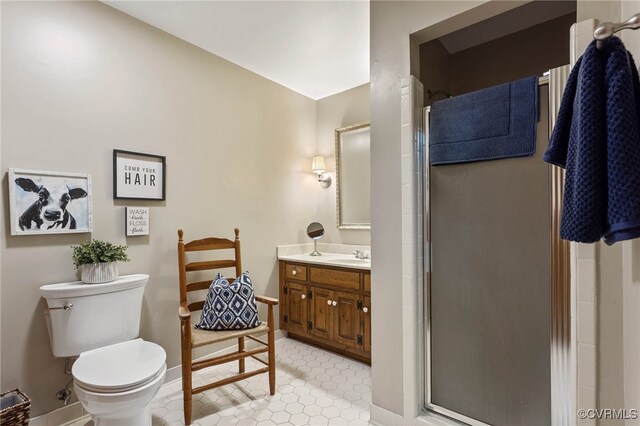 bathroom with vanity, a shower with shower door, and toilet