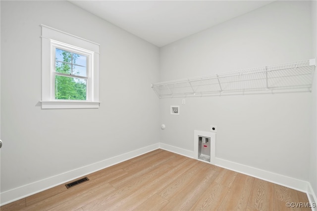 laundry room featuring electric dryer hookup, gas dryer hookup, hookup for a washing machine, and wood-type flooring