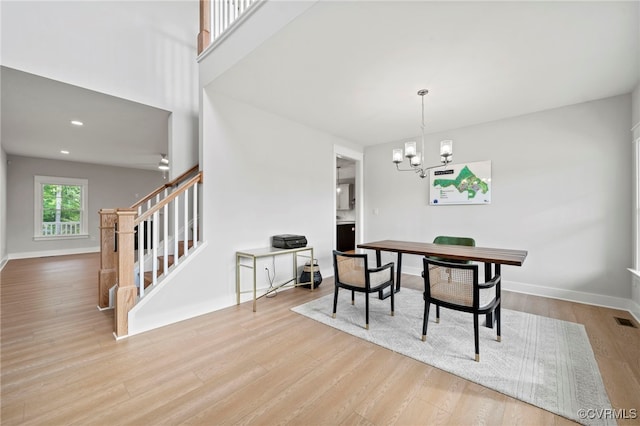 dining area with a chandelier and light wood-type flooring