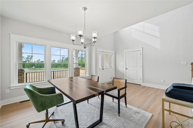 dining area featuring a chandelier and light wood-type flooring