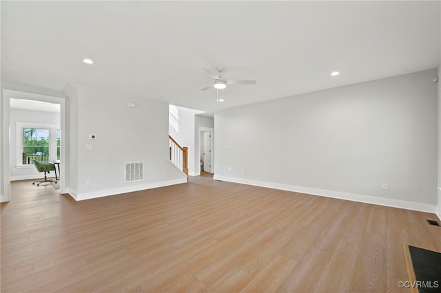 unfurnished living room featuring ceiling fan and light wood-type flooring