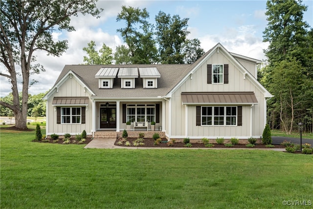 modern inspired farmhouse featuring roof with shingles, board and batten siding, and a front lawn