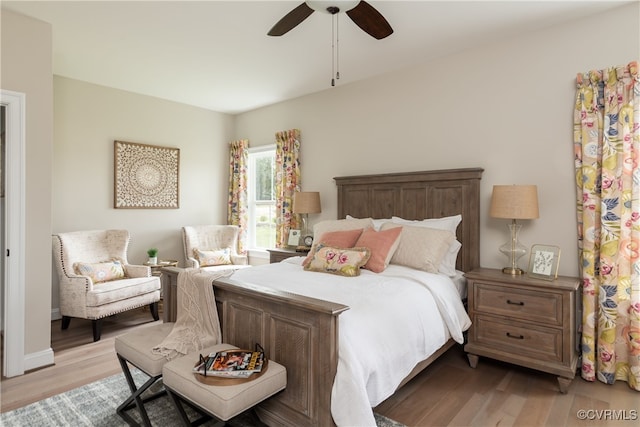 bedroom with a ceiling fan and light wood-style floors