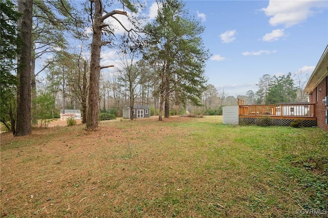 view of yard featuring a storage shed and a deck