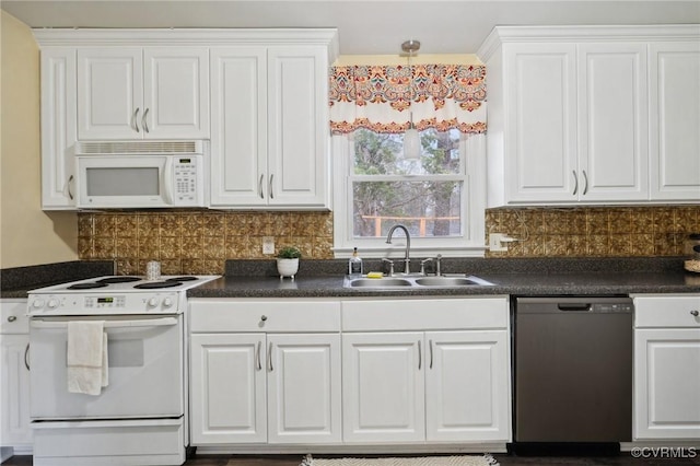 kitchen with white appliances, white cabinetry, and sink