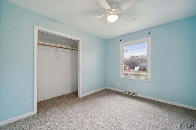 unfurnished bedroom with carpet, ceiling fan, and a closet