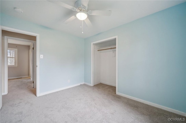 unfurnished bedroom with light carpet, a closet, and ceiling fan