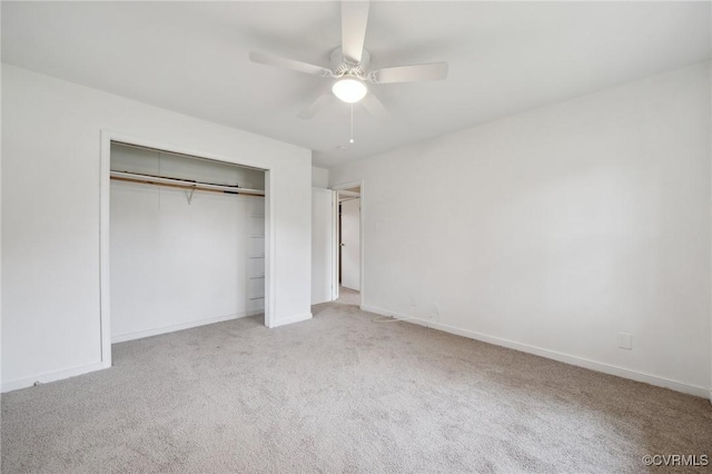 unfurnished bedroom with light carpet, a closet, and ceiling fan