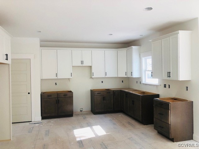 kitchen with white cabinetry and dark brown cabinetry