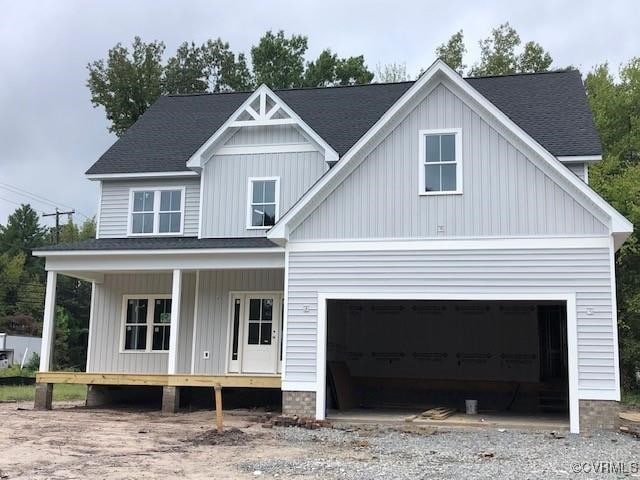 view of front of home featuring covered porch and a garage