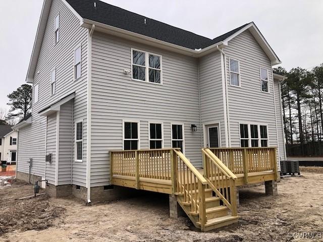 rear view of house featuring a wooden deck and central air condition unit