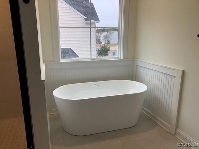 bathroom featuring a bathing tub and tile patterned flooring