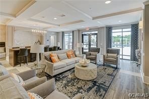 living room featuring beamed ceiling, french doors, light wood-type flooring, and coffered ceiling