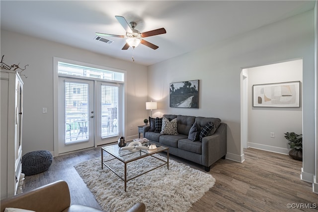 living room featuring ceiling fan, french doors, and dark hardwood / wood-style floors