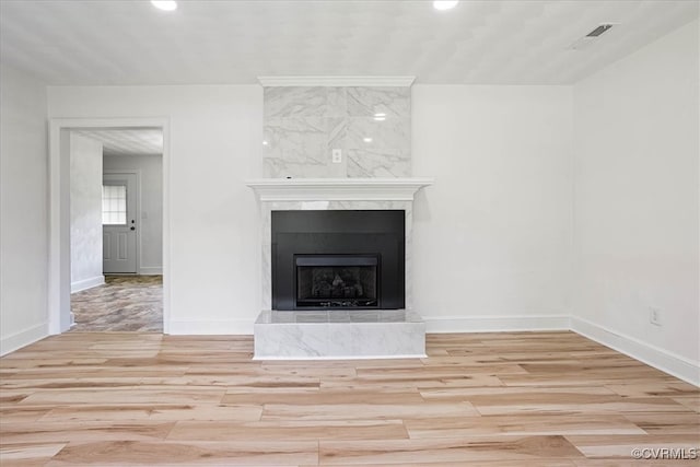 room details with a tiled fireplace and wood-type flooring