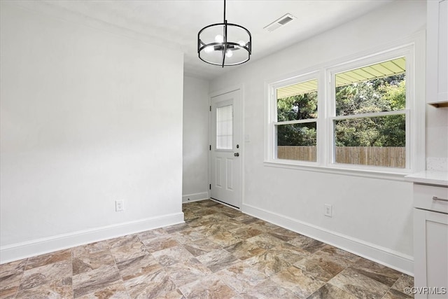 doorway featuring a notable chandelier