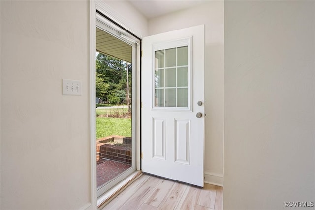 doorway to outside with light wood-type flooring