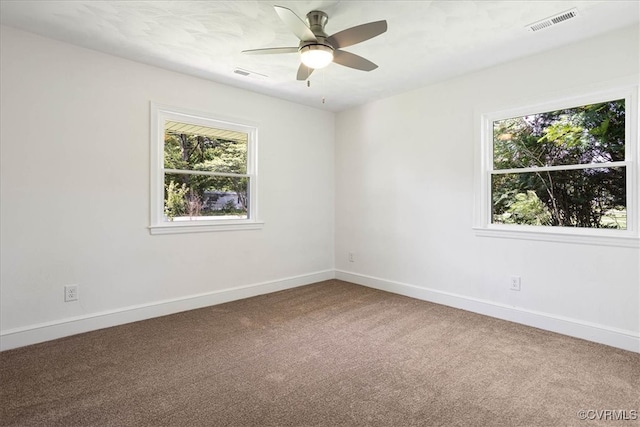 carpeted spare room with ceiling fan