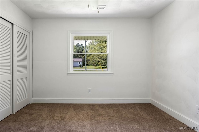 unfurnished bedroom featuring carpet flooring and a closet