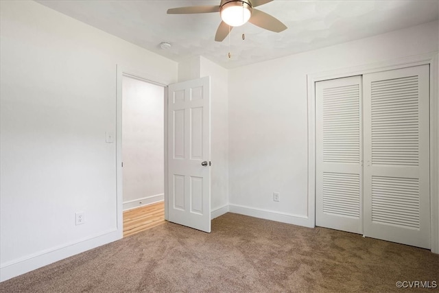 unfurnished bedroom with light carpet, a closet, and ceiling fan