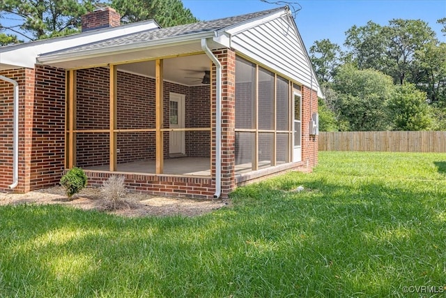 view of home's exterior featuring ceiling fan and a yard