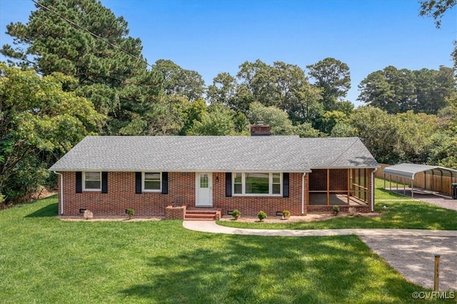 single story home with a carport, a sunroom, and a front lawn