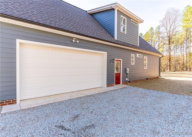 view of side of property with a garage