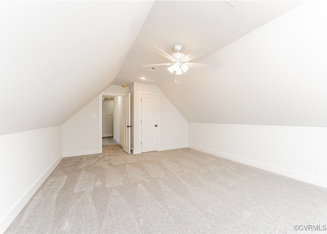 additional living space with ceiling fan, light colored carpet, and lofted ceiling