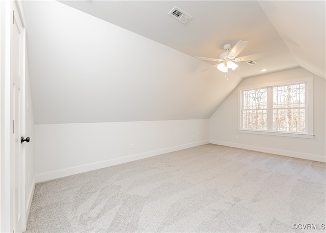 additional living space with ceiling fan, lofted ceiling, and light carpet