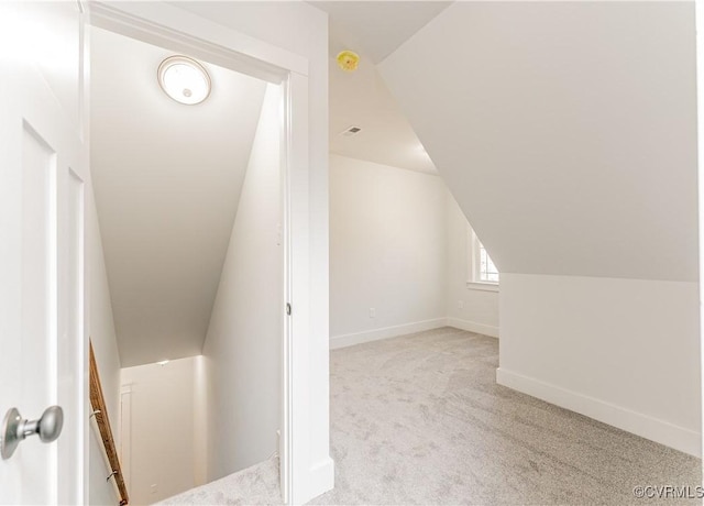 bonus room featuring light colored carpet and lofted ceiling