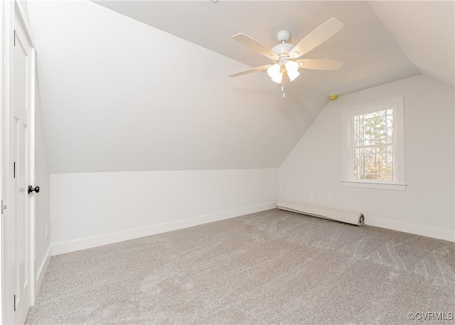 additional living space with lofted ceiling, carpet floors, and ceiling fan