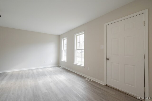 unfurnished room with light wood-type flooring