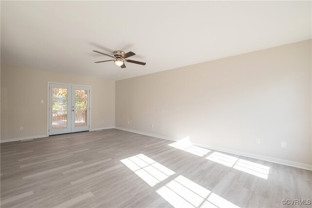 unfurnished room featuring ceiling fan, french doors, and light hardwood / wood-style flooring