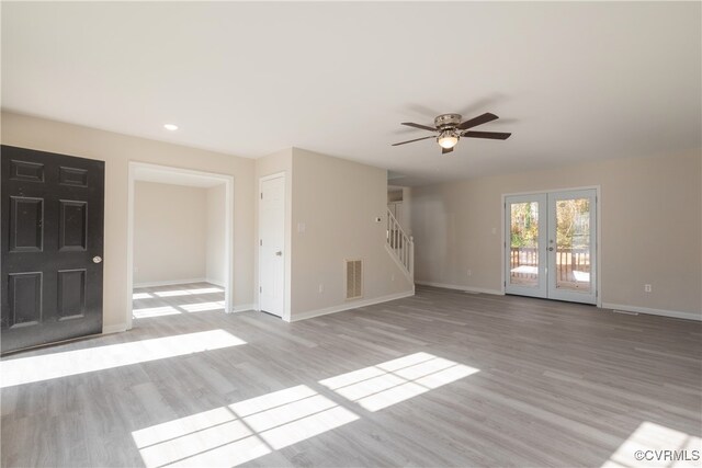 unfurnished living room featuring ceiling fan, french doors, and light wood-type flooring