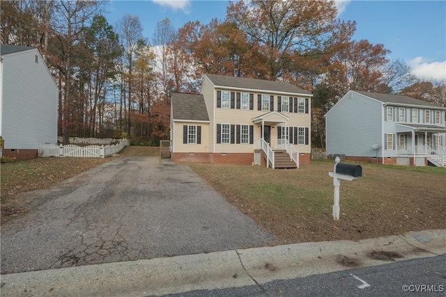 colonial-style house with a front lawn