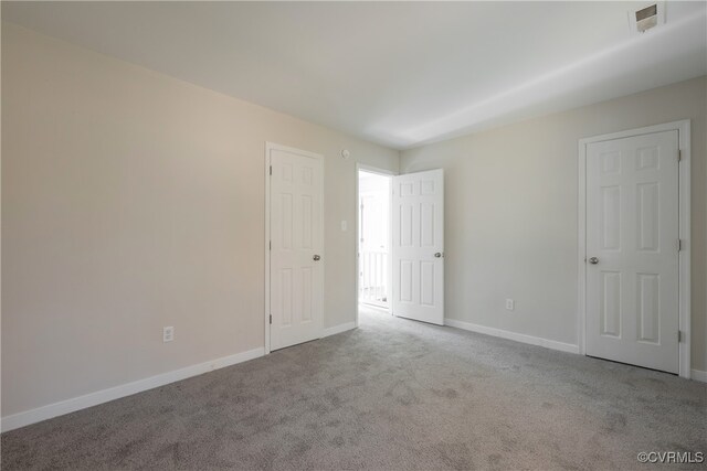 unfurnished room featuring light carpet