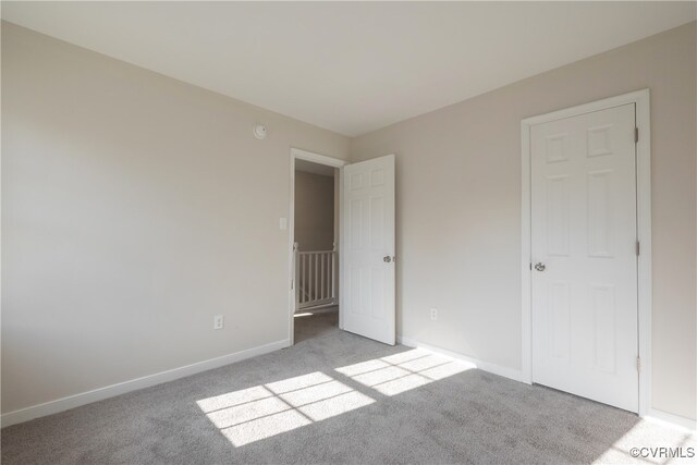 unfurnished bedroom featuring light carpet