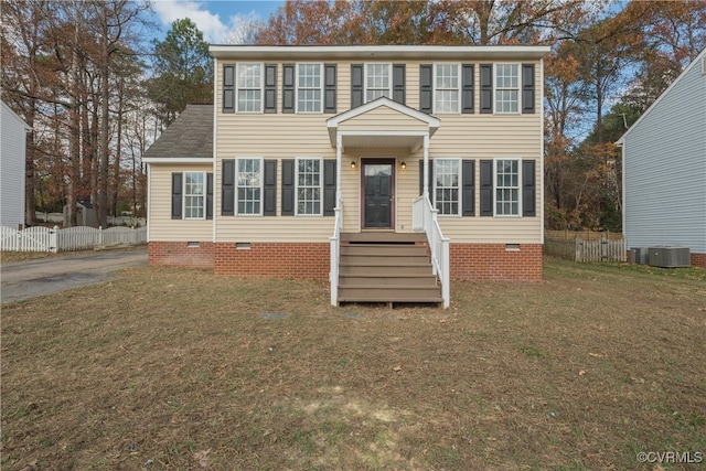 colonial home featuring a front yard