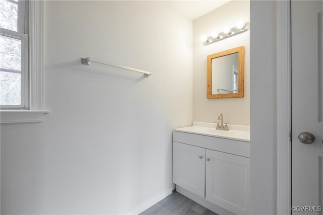 bathroom with vanity and wood-type flooring