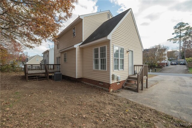 view of side of property featuring central AC and a deck