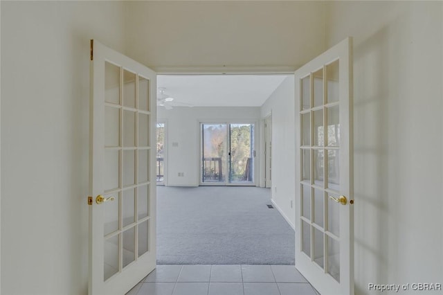 hall with light carpet and french doors