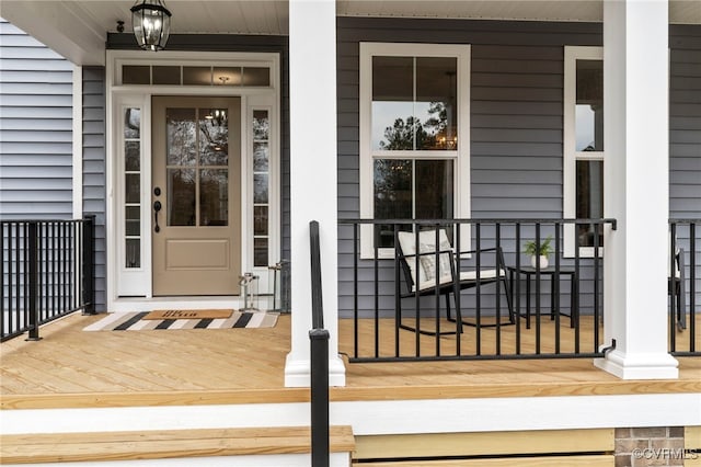 view of exterior entry featuring covered porch