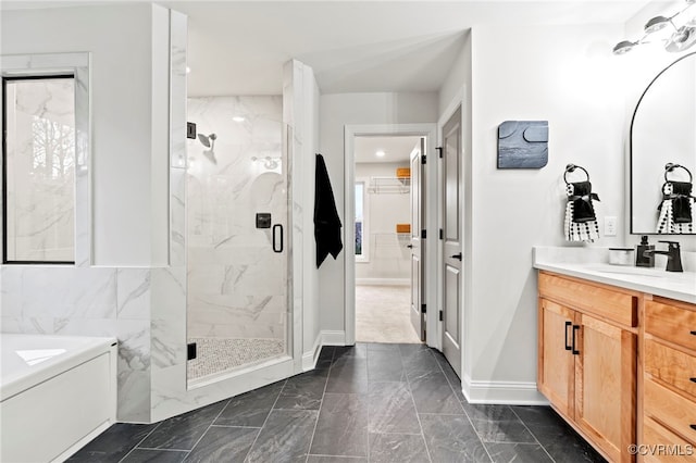 bathroom with vanity and shower with separate bathtub