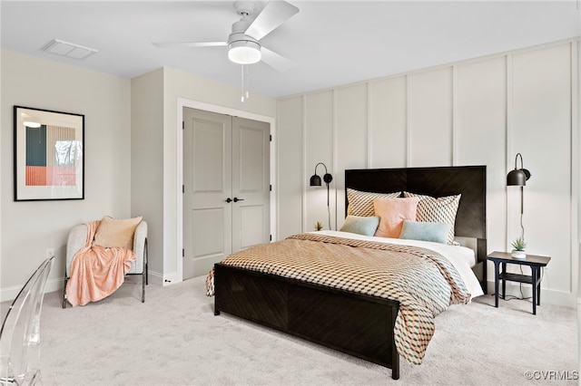 bedroom featuring light carpet, a closet, and ceiling fan