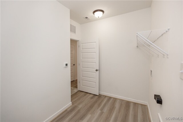 laundry room with light hardwood / wood-style flooring