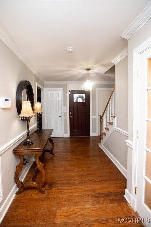 entrance foyer featuring dark hardwood / wood-style flooring and crown molding