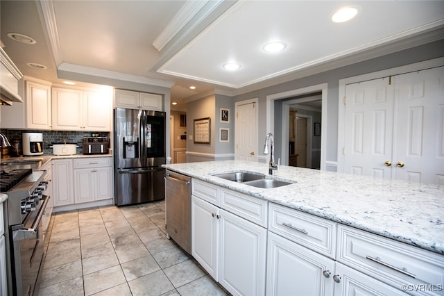 kitchen featuring sink, white cabinets, stainless steel appliances, and ornamental molding