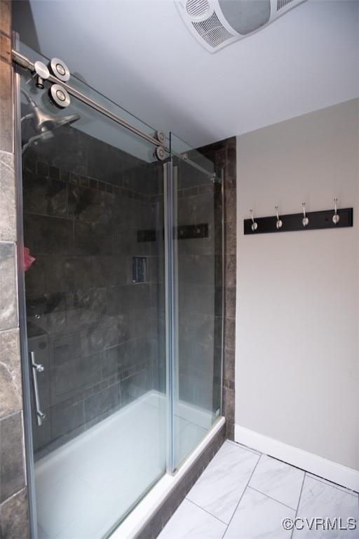 bathroom featuring a shower with shower door