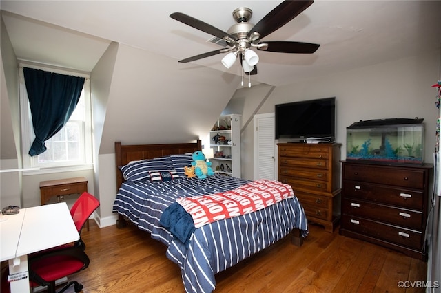 bedroom with dark hardwood / wood-style flooring and ceiling fan