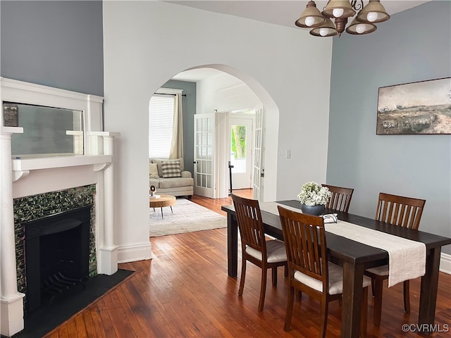 dining space with wood-type flooring and a notable chandelier